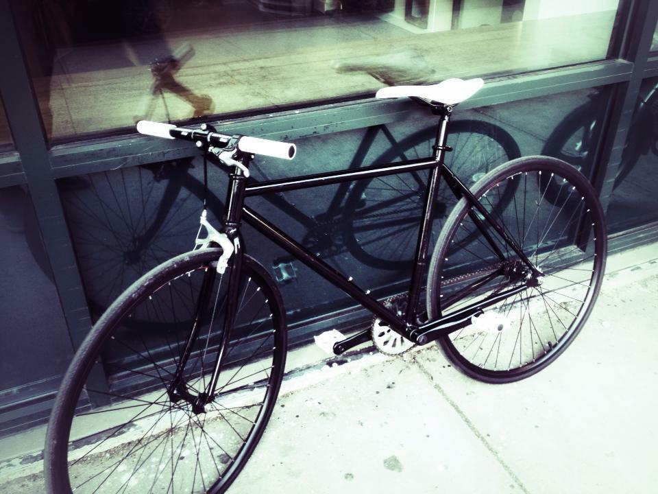black road bike with white seat, pedals, and handles (custom made)